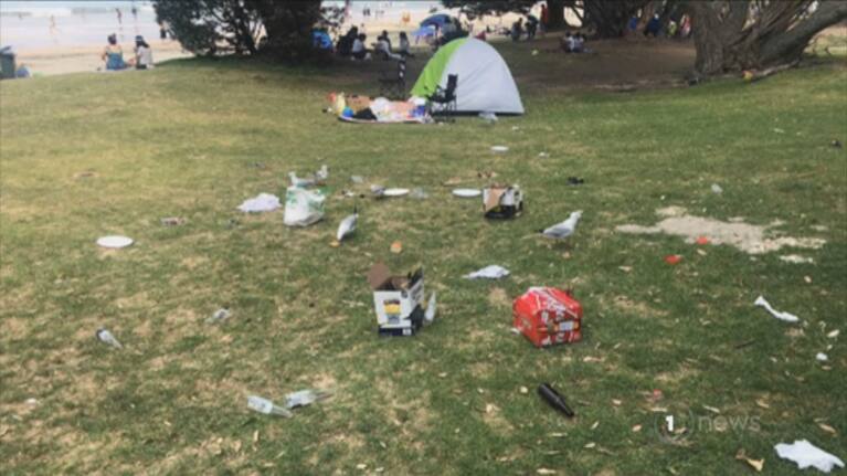 They’re investigating after a group was filmed leaving a pile of rubbish at the beach, before an angry confrontation with locals.