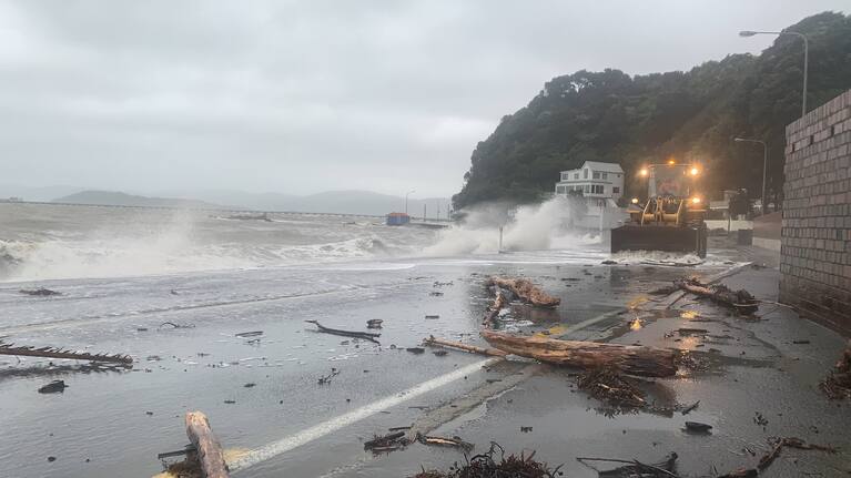 A bulldozer attempts to clear debris on Marine Drive, Eastbourne.