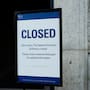 A closed sign stands in front of the National Archives on the first day of a government shutdown