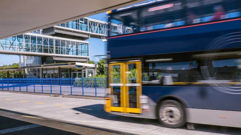 A file photo of a double-decker bus passing by a Northern Busway station in Auckland.