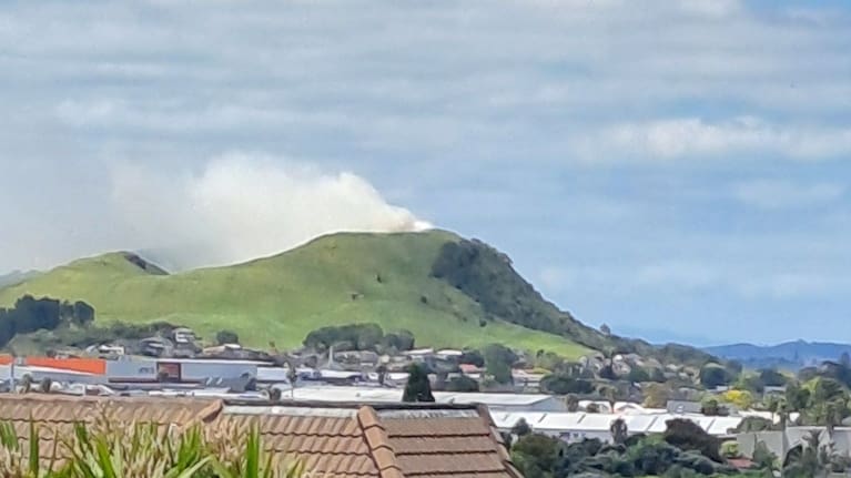 A grass fire produces smoke from Auckland's Mount Wellington.