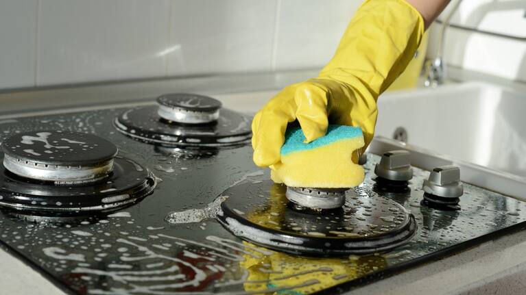 A person scrubs their stovetop (file photo).