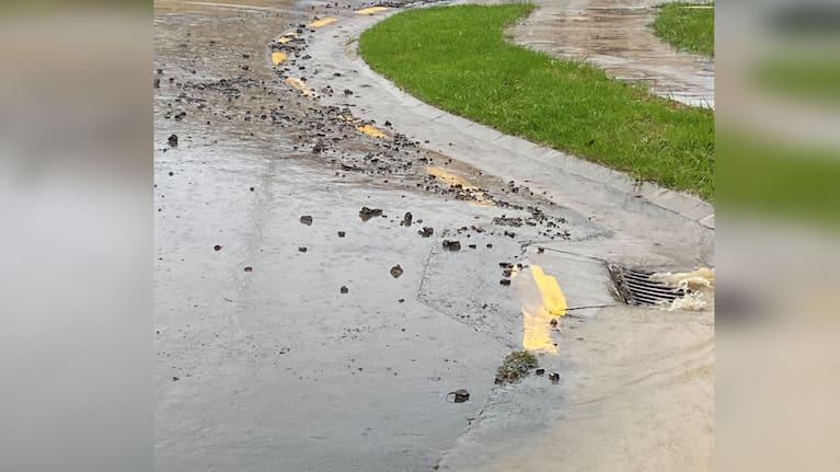 A photo showing the street after the drain was unblocked.