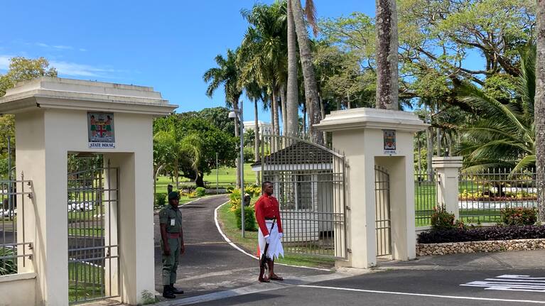 A soldier stands guard outside the President’s residence in Fiji.