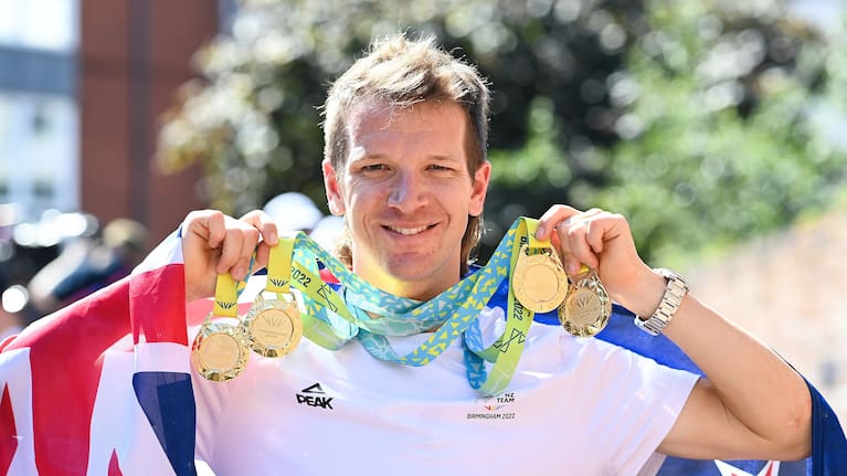 Aaron Gate with his four gold medals after being named flagbearer for the closing ceremony.