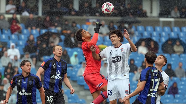Alex Paulsen clears the threat for Auckland FC.