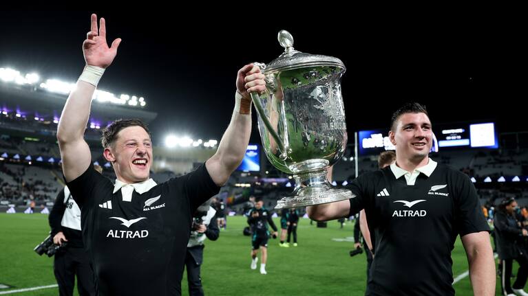 All Blacks Cam Roigard, left, and Simon Parker celebrate with the Bledisloe Cup at Eden Park.