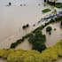 An aerial image of motorists driving amid flooding in Kaukapakapa.