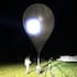 An officer inspects a balloon used to carry cigarettes into Lithuania. (Source: State Border Guard Service via AP)