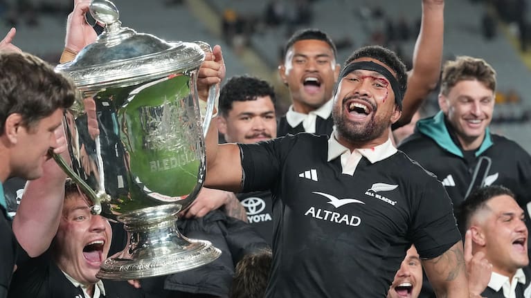 Ardie Savea celebrates with the Bledisloe Cup at Eden Park.