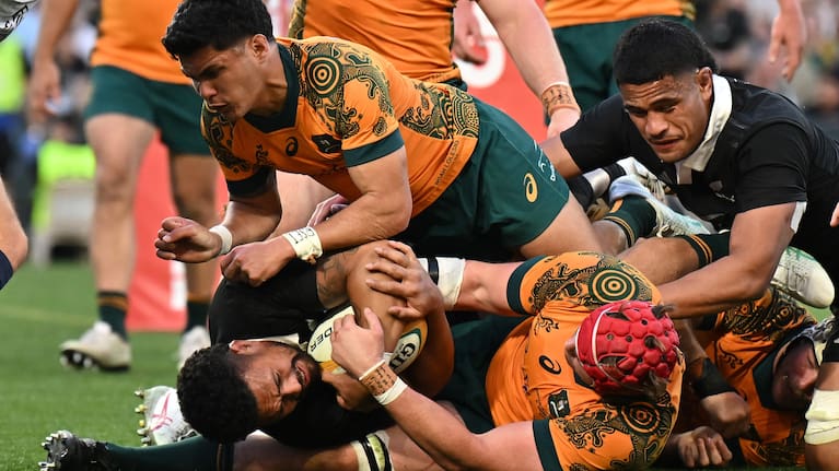 Ardie Savea is held up over the line by the Wallabies defence in Sydney.