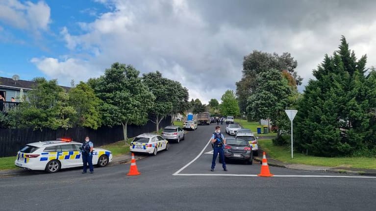 Armed officers block off Virgo Place, in Auckland's Glen Eden, after a gang-related assault.