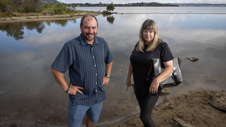 At the Utuhina Stream mouth, Rotorua residents Gary Coker and Tracey McLeod swap stories of voluntary litter collection in the city.