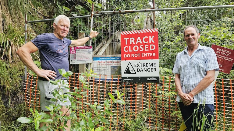 Austin Oliver and Angus Robson at the cordoned off entrance to a once popular walking track. (Source: Diane McCarthy / LDR)