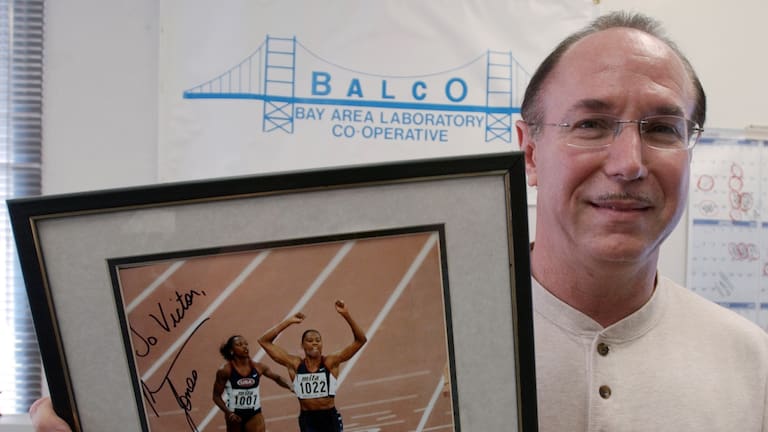 BALCO founder Victor Conte holds up an autographed photo addressed to Conte of track star Marion Jones in his office in Burlingame, Calif., Oct. 21, 2003.