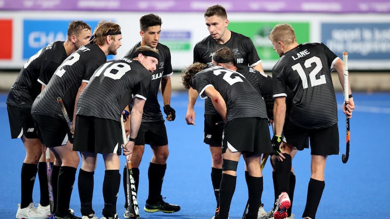 Black Sticks men's players in a huddle at the 2022 Commonwealth Games in Birmingham.