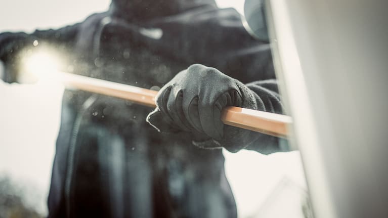 Burglar picking lock.