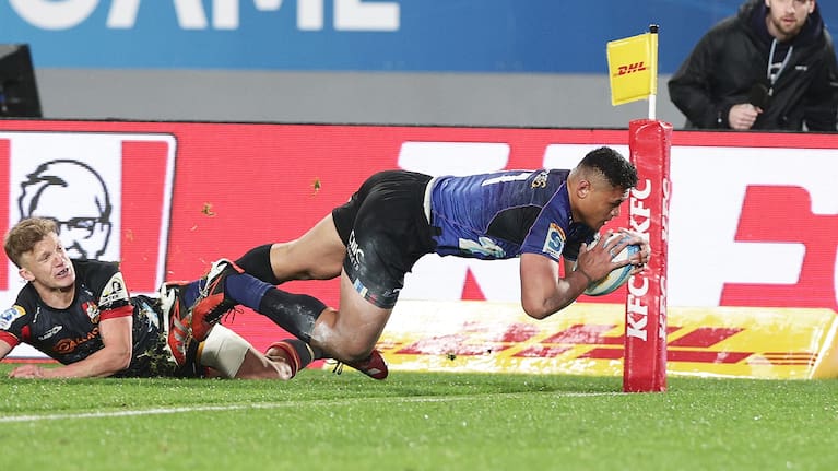 Blues wing Caleb Clarke scores his hat-trick try against the Chiefs.