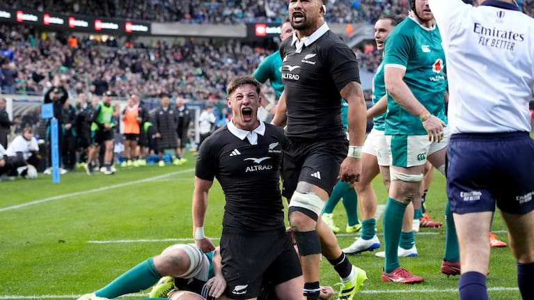 Cam Roigard and Ardie Savea celebrate Roigard's try against Ireland in Chicago.