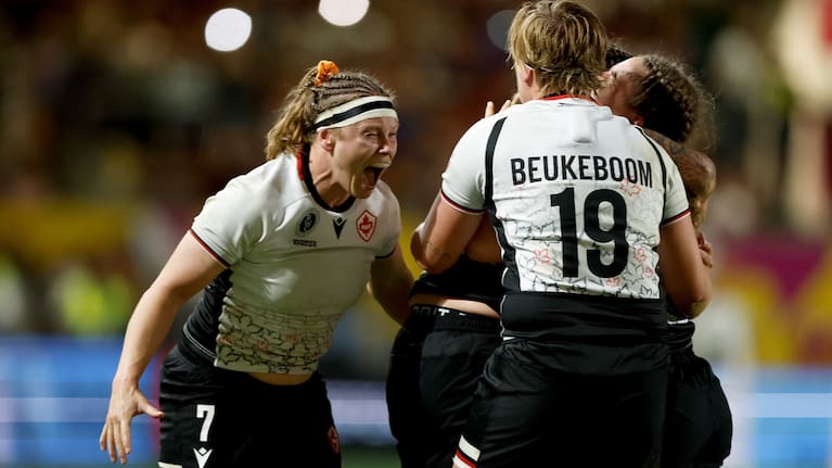 Canada celebrate their victory over the Black Ferns.