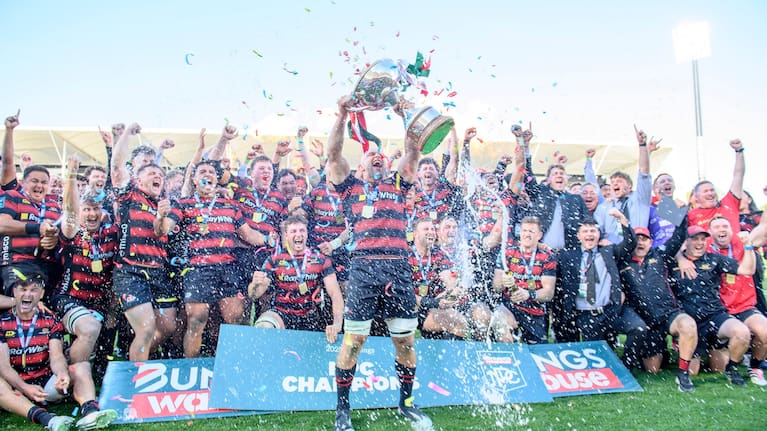 Canterbury skipper Tom Christie celebrates with the NPC trophy after his team's grand final win over Otago.