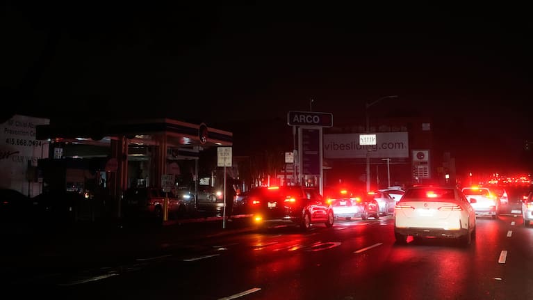 Cars wait at an intersection with no working traffic lights from power outages, in San Francisco, Saturday, Dec. 20, 2025.