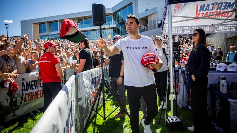 Charlie Kirk hands out hats before speaking at Utah Valley University in Orem, Utah.