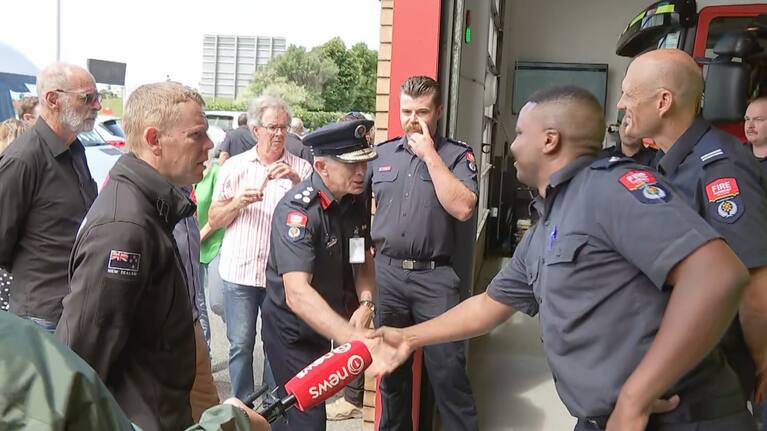Chris Hipkins greets firefighters in West Auckland.