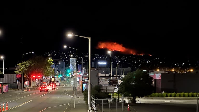 The fire in Christchurch's Port Hills continues to burn overnight, with crews staying to fight the flames.