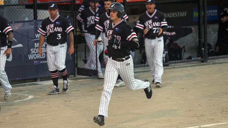 Cole Evans runs in to score for the Black Sox.