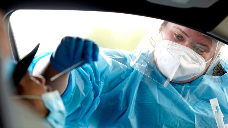 Shania Dod collects a sample at a United Memorial Medical Centre Covid-19 testing site.