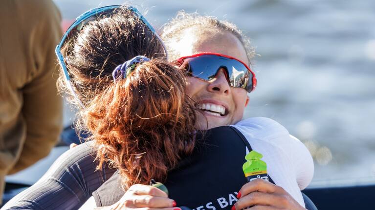 Dame Lisa Carrington and Aimee Fisher embrace after their first race.