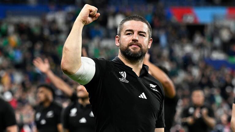 Hooker Dane Coles gestures to the All Blacks fans in the Stade de France crowd after his team's recent victory over France.