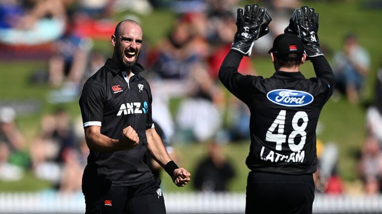 Daryl Mitchell celebrates a wicket with Tom Latham.