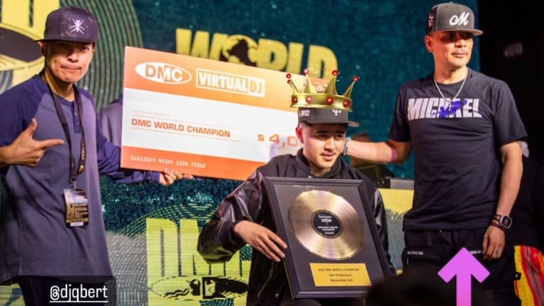 DJ K-Swizz, centre, holding his trophy as the repeat DMC world champion.
