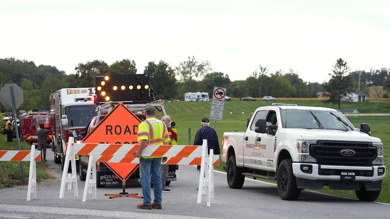 Emergency personnel block a road after a shooting involving police officers.