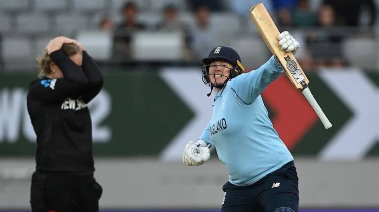England's Anya Shrubsole celebrates after hitting the winning runs as Brooke Halliday can't look.