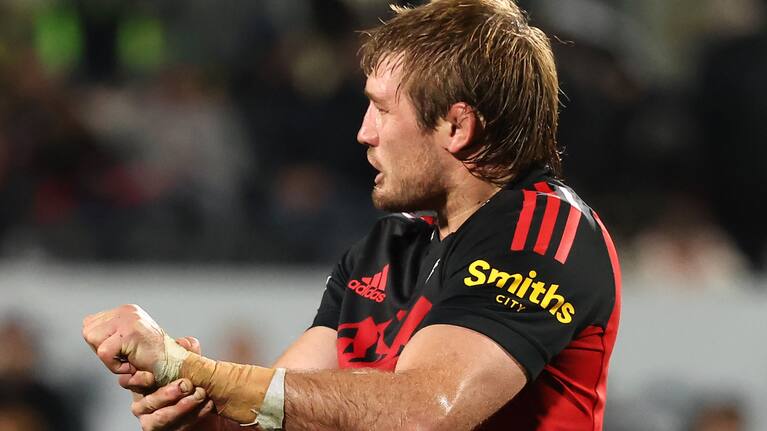 Ethan Blackadder leaves the pitch grimacing in pain after dislocating his shoulder against the Reds.