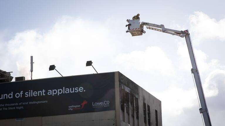 A firefighter looks down at the damage at Loafers Lodge.