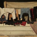 From a damaged building turned into a shelter, a Palestinian woman observes members of the Hamas militant group searching for bodies of the hostages in an area in Hamad City, Khan Younis, in the southern Gaza Strip