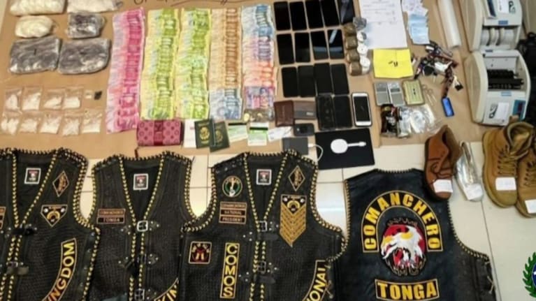 Gang paraphernalia seized by police in Tonga, including Comanchero t-shirts and patches.