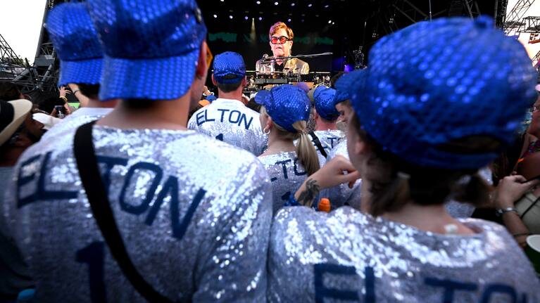 The crowd watch Elton John perform on stage during Day 5 of Glastonbury Festival.