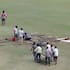 Ground staff try to prepare the pitch for play at Greater Noida.
