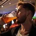 Gustavo Candido drinks liquor at a bar in Sao Paulo, Friday, Oct. 3, 2025.