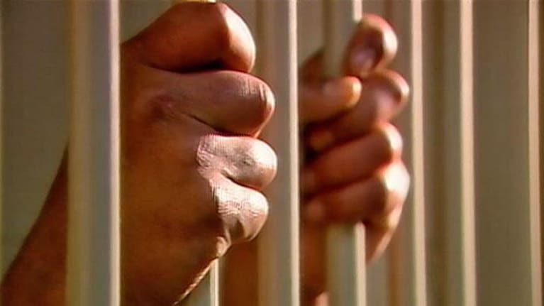 Prisoner in jail cell.