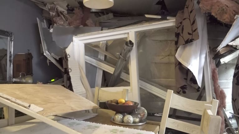 Insulation can be seen coming out of the walls following flood and landslide damage to Fiona Cadogan's Dunedin home.