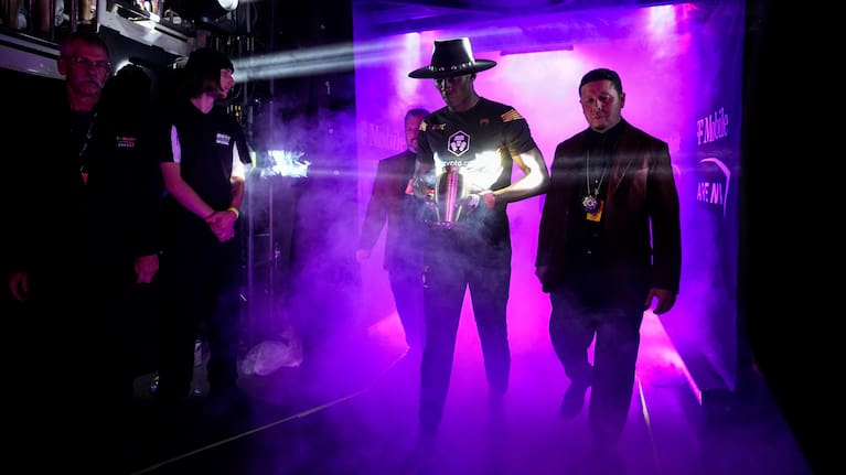 Israel Adesanya mimics The Undertaker as he walks to the octagon at the T-Mobile Arena in Las Vegas.