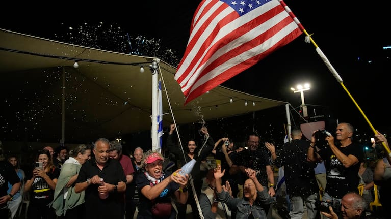 Relatives and supporters of Israeli hostages held by Hamas in the Gaza Strip celebrate after the announcement that Israel and Hamas have agreed to the first phase of a peace plan, as they gather at a plaza known as the hostages square in Tel Aviv