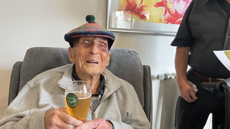 Jack Coe enjoys a beer on his 107th birthday.
