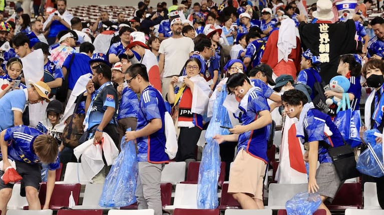 Japanese fans pick up trash at the end of the FIFA World Cup Qatar 2022 Group E match against Germany.
